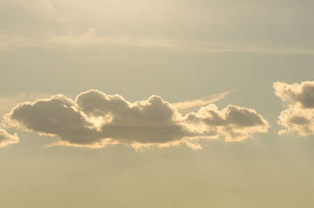 Clouds illuminated by the sun in the sky as background. Background image for further editingの写真素材