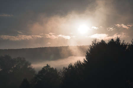 sunrise with fog in the early morning hours. mystical atmosphere. Taken in Saarland in beautiful landscapeの写真素材