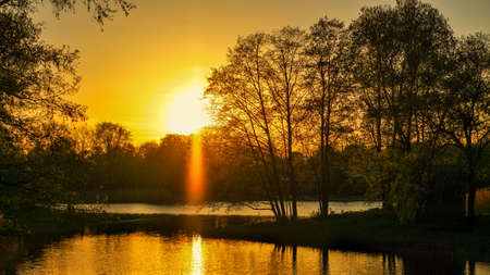 Setting sun on the outskirts of Berlin. The sky seems to burn. Romantic evening sky.の写真素材