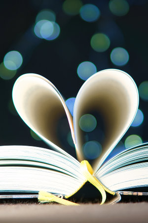 opened buck with sides that are beaten to the heart. Light spot by fairy lights in background with soft bokeh. Love novel for romance.の写真素材