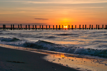 Sunset on the Baltic Sea. Sea, groyne strong colors. Vacation on the beach. Romantic mood on the...