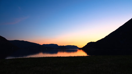 Fjord with view of mountains and fjord landscape in Norway. Landscape shot in the evening in the north with bright sky.の写真素材