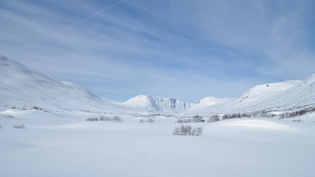 Norwegian high mountains in the snow. Mountains covered in snow. Scandinavian landscape in the far northの写真素材
