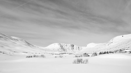 Norwegian high mountains in the snow. Mountains covered in snow. Taken in black and white. Scandinavian landscape in the far northの写真素材
