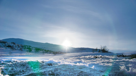 Norwegian high mountains in the snow. Mountains covered in snow. Scandinavian landscape in the far northの写真素材