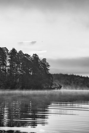 Sunrise with fog forming over a lake in Sweden, at dawn. Romantic silence, in the Scandinavian natureの写真素材