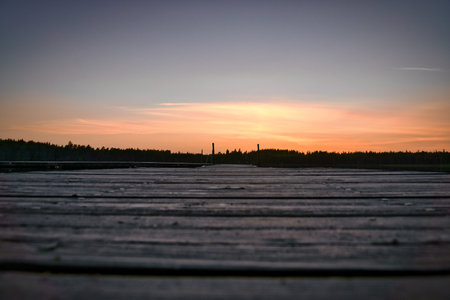 Wooden jetty at sunset on a lake. Romantic evening atmosphere. Scandinavian natureの写真素材