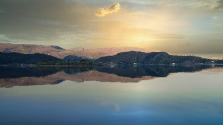 Fjord with view of mountains and fjord landscape in Norway. Blue sky, white clouds, calm...