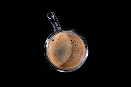 black coffee in a glass transparent cup on a black background. view from aboveの写真素材