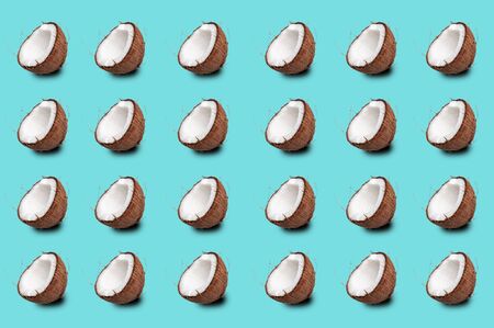 coconut pattern on a turquoise background. coconut halves are repeated many times.
