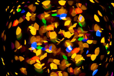 abstract christmas bokeh background with colorful lights on dark background. High quality photo