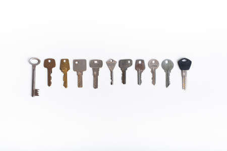 collection of different house keys isolated on white backgroundの写真素材