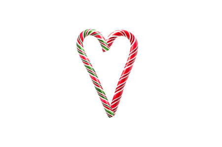 Heart made of candy canes on white background