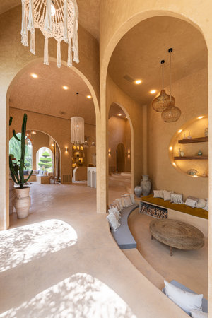 Interior of a luxury hotel room with arches and round tables