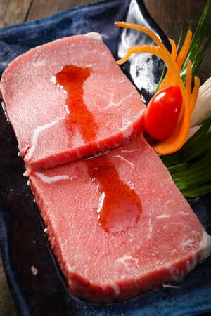 Set of beef slice on wooden background uncookedの写真素材