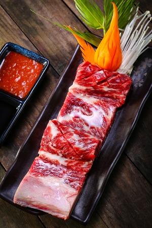 fresh beef back ribs on wooden background uncookedの写真素材
