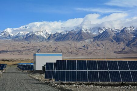 Photovoltaic power station at the foot of the snow mountainの写真素材
