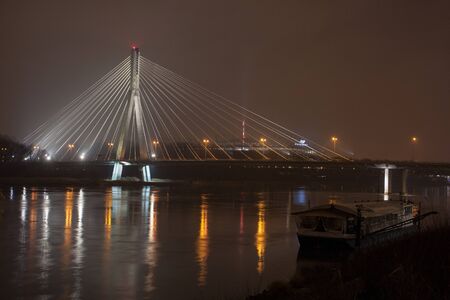 suspension bridge on the river at night