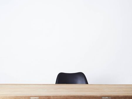 Studio photo of wood table and modern black chair  isolated on white background.