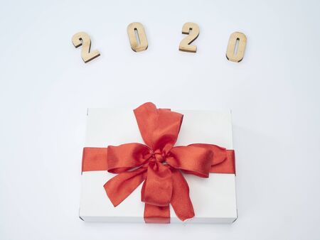 Christmas and New Year greeting card with composition festive decorations. Gift boxes and symbol from number 2020 on white background.の写真素材