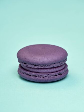 Bright colorful macarons on a pastel blue background. space for text, close upの写真素材