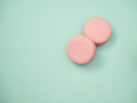 Pink macarons on pastel blue background. space for text, close upの写真素材