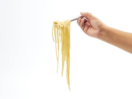 hand holding roll pasta spaghetti with a fork on white background. Space for text.の写真素材