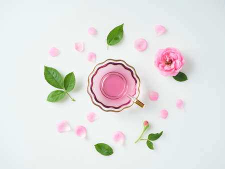 Spa set. Bottles of essential oil, roses and scented candles on white background