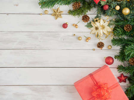Christmas composition with gift box and decorated fir tree on white rustic wooden background