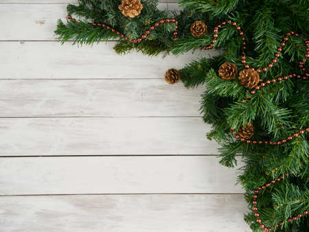 Fir tree branches with Christmas decorations on white wooden background. Top view, space for textの写真素材