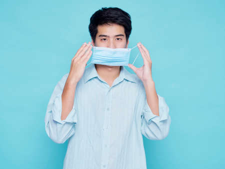 Portrait of handsome young men wearing medical mask ready for summer vacation travel, concept covid 19の写真素材