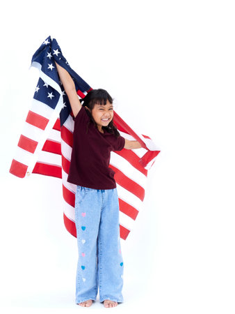 Portrait of cute little girl with American flag on white backgroundの写真素材