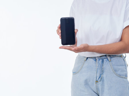 Woman showing smartphone on white background, closeup. Space for textの写真素材