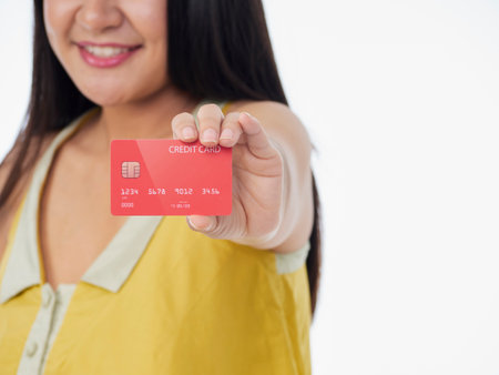 Woman holding credit card on white background. Space for textの写真素材