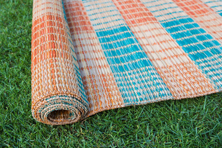 Traditional Thai mat on the green grass, Close up from top viewの写真素材