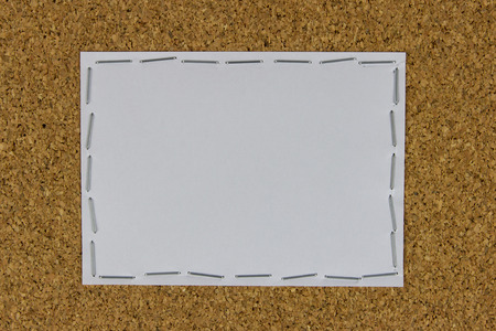 white paper attached on the cork brown board by stapler の写真素材