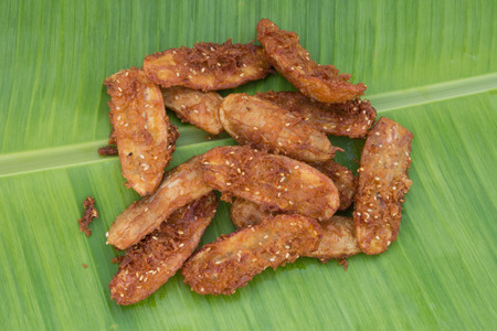 Fried banana on green banana leaf の写真素材