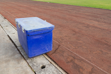 big blue ice bucket on the running trackの写真素材