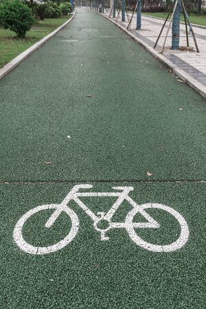 Green bicycle lane for biking, beside the walkwayの写真素材