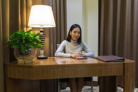 Asian girl like working woman, getting an interview on her deskの写真素材