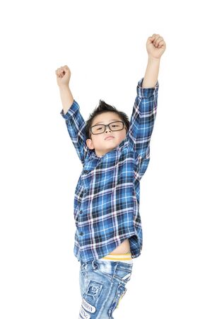 Little boy in glasses raise hands up on whiteの写真素材