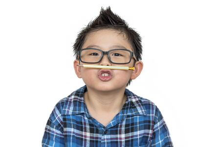 Asian boy in glasses with his funny face on white background on isolatedの写真素材