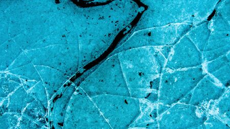 View of beautiful drawings on ice from cracks. A tiny world in the largest one