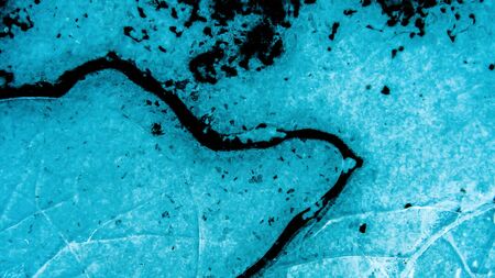 View of beautiful drawings on ice from cracks. A tiny world in the largest one