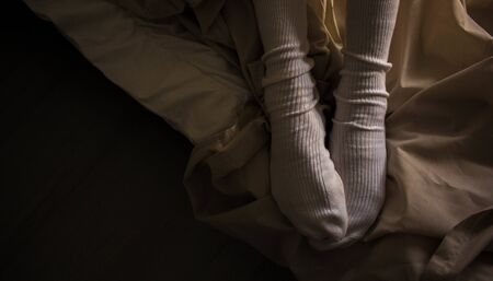 women's feet in white stockings white socks on the bed style background screensaver picture decor nostalgia romance picture for classical musicの写真素材
