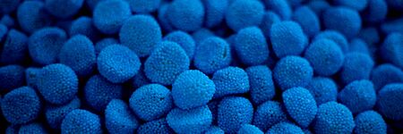 blue marmalade in the form of blackberries in a pile. lots of blue marmalade background texture screensaver chewy marmaladeの写真素材
