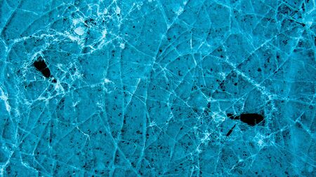 View of beautiful drawings on ice from cracks. A tiny world in the largest one