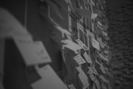 paper stickers with different inscriptions and drawings glued to the wall. paper stickers for notes....