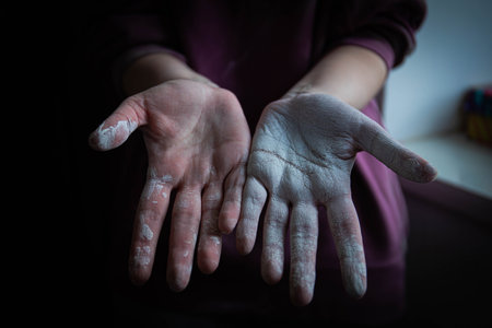beautiful women's hands smeared in white paint after working with their hands. home renovation. painting works. hands covered in paint. whitewashing the textureの写真素材