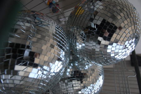 disco balls lying in the basket on top of each other disco balls behind the bars balls from the mirrorの写真素材